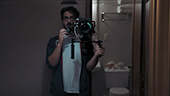 Still image of Matthew Solomon holding his camera rig.